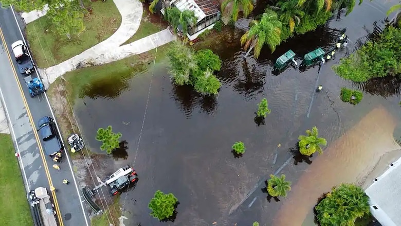 Eustis, Fla. – The U.S. Army Corps of Engineers (USACE), in coordination Lake County Emergency Management and state partners, has mobilized personnel to provide technical assistance with the ongoing flood response efforts in Lake County following recent heavy rainfall across the region. Workers can be seen laying out long suction hoses.( U.S. Army Photo by Brigida I. Sanchez)