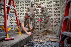U.S. Air Force Airmen assigned to the 11th Combat Air Base Squadron, level the ground to install a concrete base at Kadena Air Base, Japan, Oct. 27, 2025. The 11th CAB is a forward-deployed support unit made up of Airmen from different squadrons and bases, who work together to build, operate, and enable mission-essential infrastructure at contingency locations across the Indo-Pacific. (U.S. Air Force photo by Airman Nathaniel Jackson)