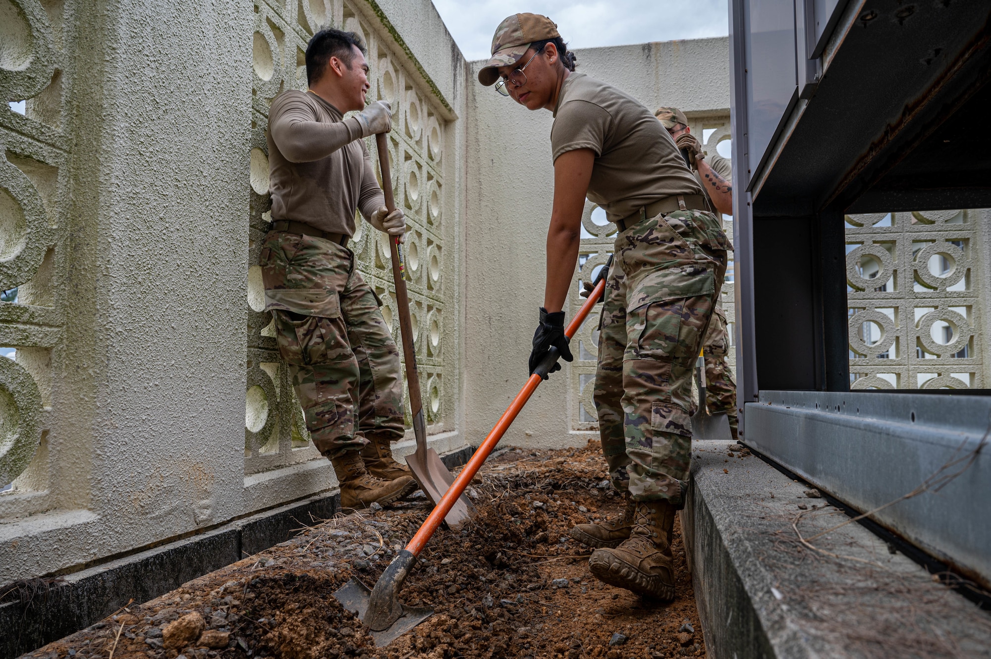U.S. Air Force Airmen assigned to the 11th Combat Air Base Squadron, level the ground to install a concrete base at Kadena Air Base, Japan, Oct. 27, 2025. Their joint effort highlights how Airmen from different squadrons, forward deployed to Kadena, come together as one unit to sustain vital infrastructure and keep Indo-Pacific operations running. (U.S. Air Force photo by Airman Nathaniel Jackson)