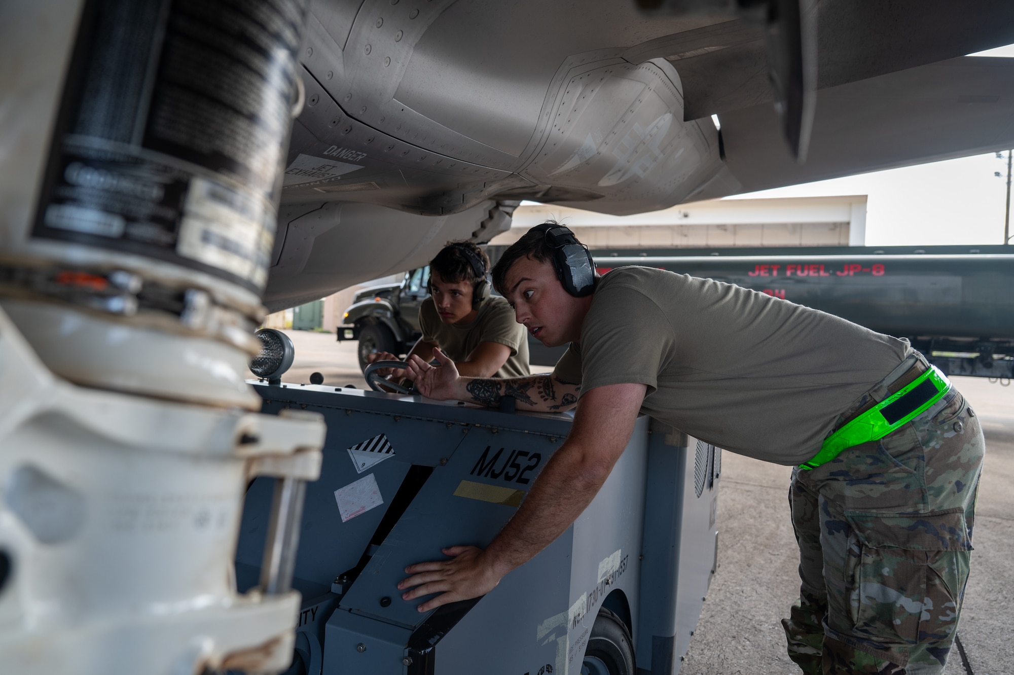 U.S. Air Force Airmen load munitions onto aircraft.