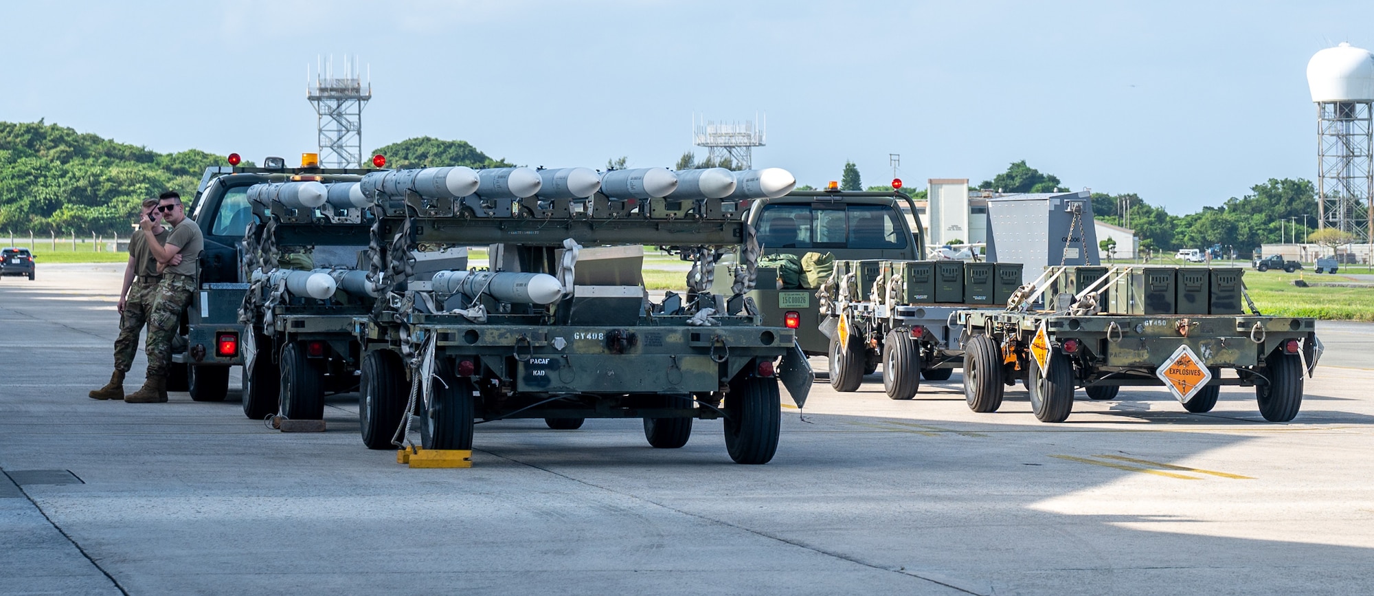 U.S. Air Force Airmen prepare to load munitions onto aircraft.
