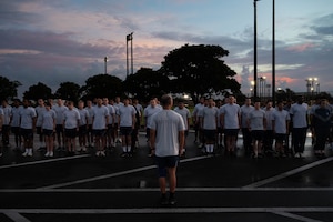 Airmen stand in formation in their physical training uniform.