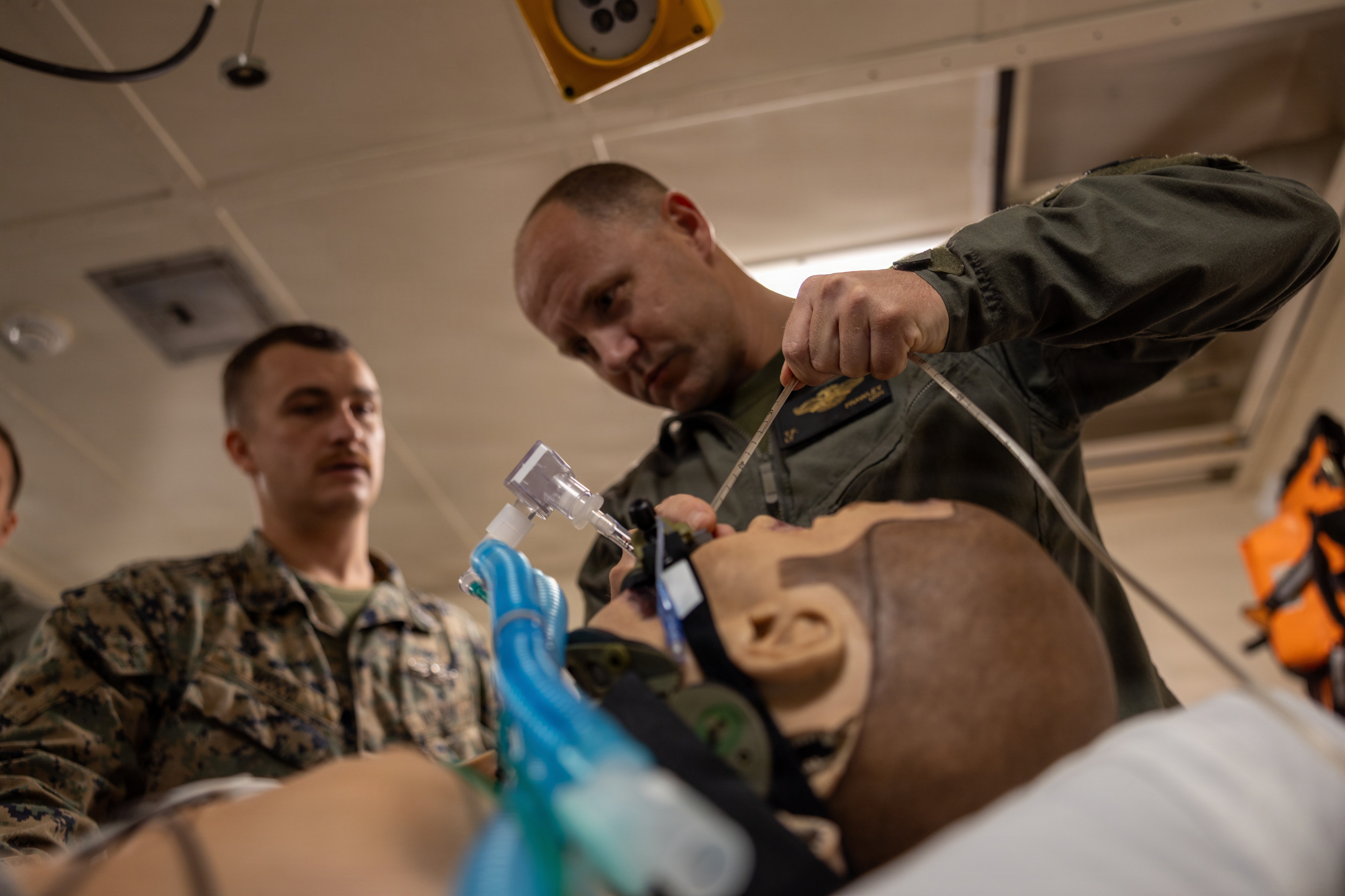 CARIBBEAN SEA - U.S. Navy Lt. Thomas Frawley, an en route care nurse with Combat Logistics Battalion 26, 22nd Marine Expeditionary Unit (Special Operations Capable), demonstrates the placement of an orogastric tube during ERC training aboard San Antonio-class amphibious transport dock ship USS San Antonio (LPD 17) while underway in the Caribbean Sea, Oct. 25, 2025. U.S. military forces are deployed to the Caribbean in support of the U.S. Southern Command mission, Department of War-directed operations, and the president’s priorities to disrupt illicit drug trafficking and protect the homeland. (U.S. Marine Corps photo by Staff Sgt. Brett Norman)
