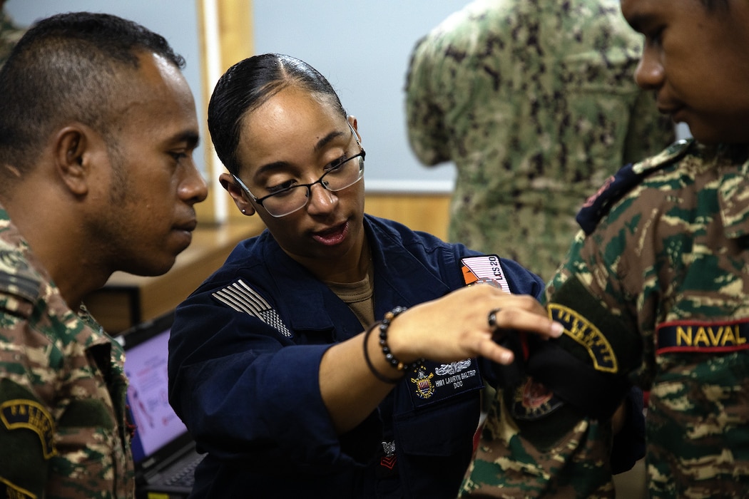 Dili, Timor-Leste (Sept. 23, 2025) - Hospital Corpsman 1st Class Lauryn Baltrip, assigned to Independence-variant littoral combat ship USS Cincinnati (LCS 20), demonstrates lifesaving techniques to Timor-Leste Defense Forces (F-FDTL) first responders during a tactical combat casualty course as part of Cooperation Afloat Readiness and Training (CARAT) Timor-Leste 2025 at Port Hera Naval Base, in Dili, Timor-Leste Sept. 23, 2025. This year marks the 14th iteration of CARAT Timor-Leste and the 31st iteration of CARAT, a multinational exercise series designed to enhance the U.S. Navy’s and partner navies' abilities to operate together in response to traditional and nontraditional maritime security challenges in the Indo-Pacific region. (U.S. Navy photo by Chief Mass Communication Specialist Mike Wright)