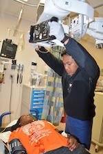 251017-N-ME175-1004 JACKSONVILLE, FL Hospital Corpsman 2nd Class Ethan Rim simulates an x-ray on a victim during a Code Grey Mass Casualty drill at Naval Hospital Jacksonville Oct. 17. The last similar drill the hospital held was in 2023.  U.S. Navy Photo by Julie M. Lucas