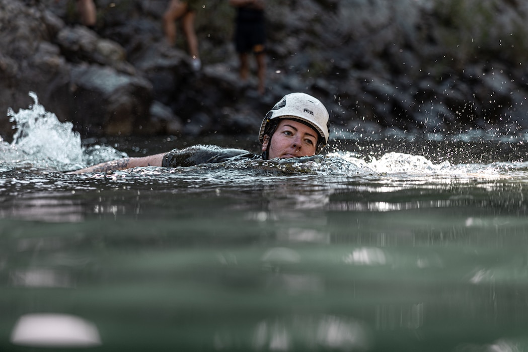 U.S. Navy Hospital Corpsman 2nd Class Sierra Juergens, California native, with 1st Medical Battalion, 1st Marine Logistics Group, swims during stream crossing exercises as part of Mountain Medicine 3-25 at Marine Corps Mountain Warfare Training Center, Bridgeport, California, Sep. 7, 2025. MMED challenges service members with various medical and technical problems common to mountainous environments in preparation for future conflicts in austere terrain. (U.S. Marine Corps photo by Lance Cpl. Enge You)