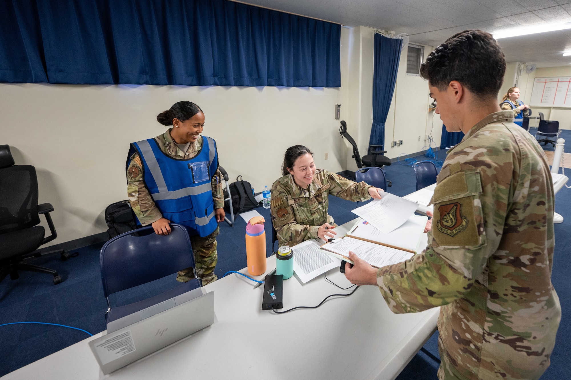 Service members look over documents.