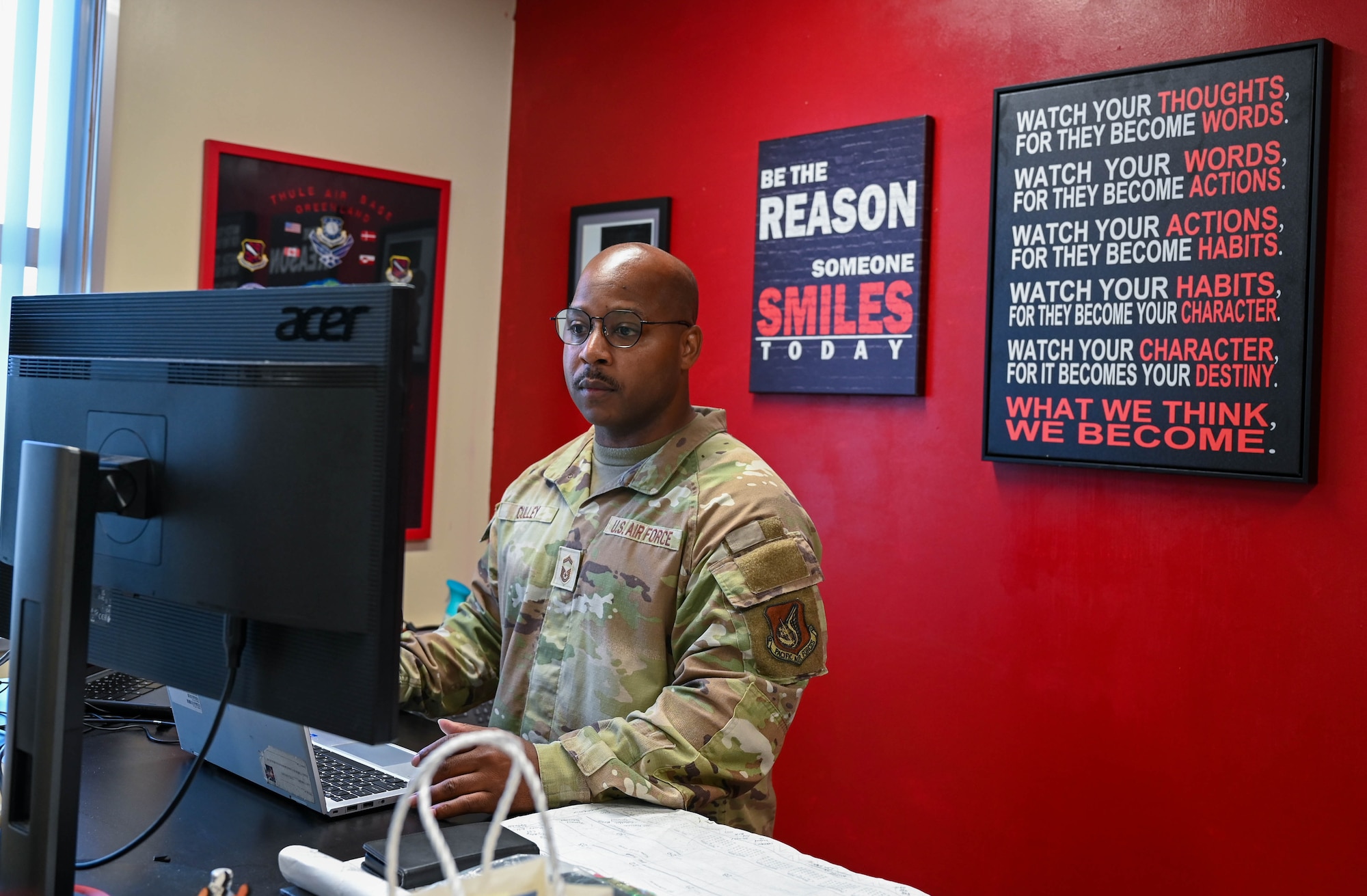 Service member working at computer.