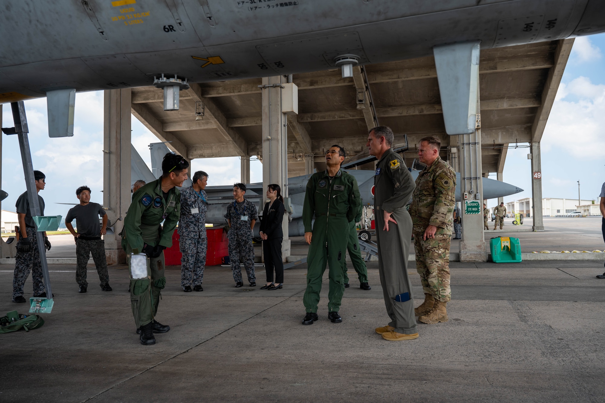 Service members look over aircraft.