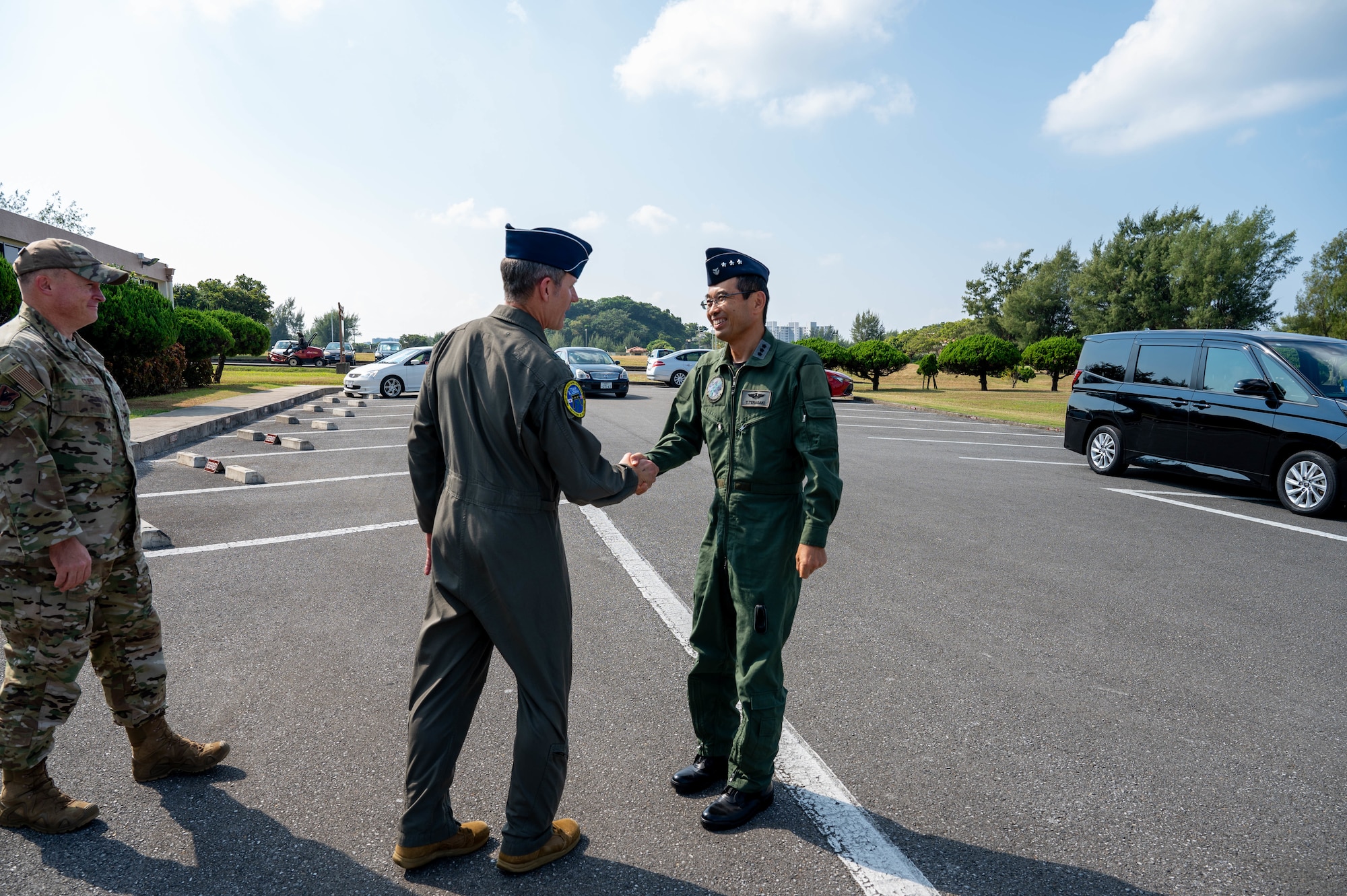 Service members shake hands.