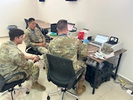 MAJ Pow Sang (middle), Chief of Microbiology at WRAIR-Africa, teaches soldiers how to use BioFire equipment for disease surveillance at African Lion 2025.