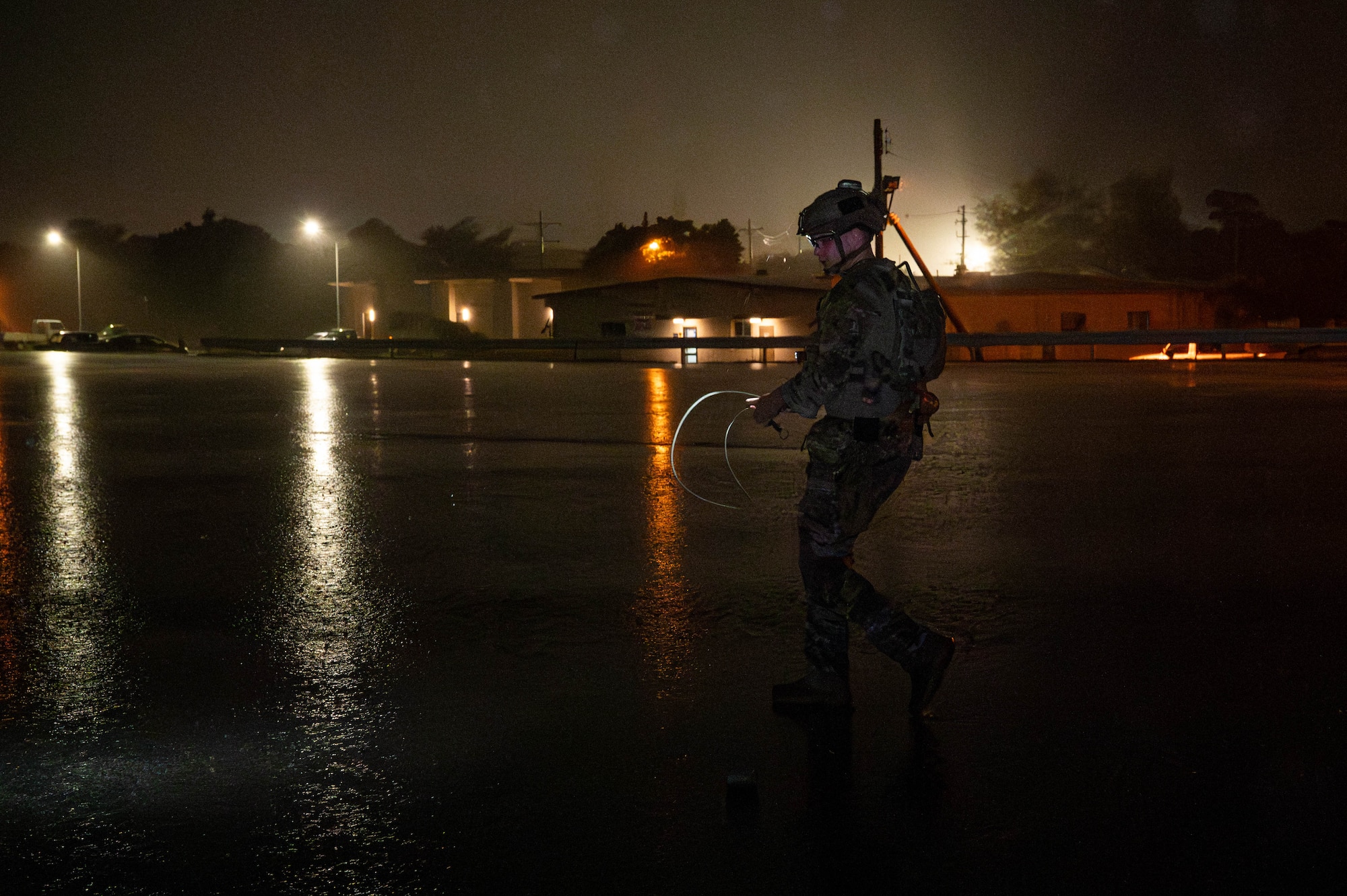 U.S. Air Force Senior Airman Cody Fain, 18th Civil Engineer Squadron explosive ordinance disposal team member, prepares to place C-4 on simulated unexploded ordnance during a mass mechanical clearance exercise in support of BH 26-1 at Kadena Air Base, Japan, Nov. 4, 2025. The training focused on rapidly removing submunitions from the runway to return the airfield to full operational capability. (U.S. Air Force photo by Airman Nathaniel Jackson)