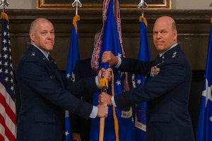General Bussiere and General Davis pass a guidon for a change of command ceremony.