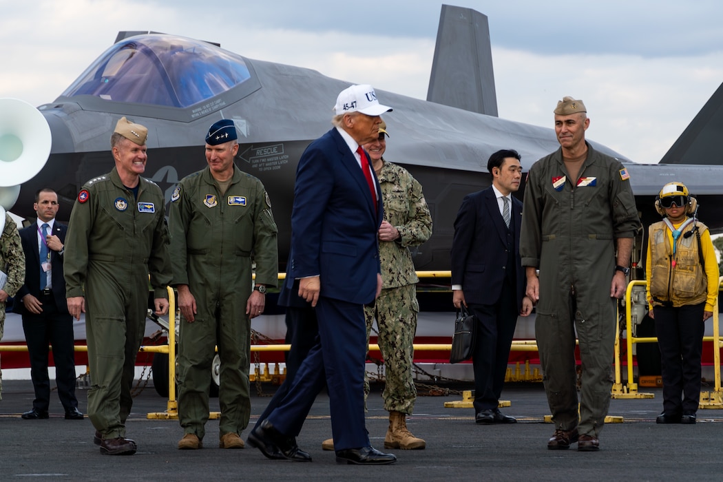 President Donald Trump, walks on the flight deck of Nimitz-class aircraft carrier USS George Washington (CVN 73) during a presidential visit while moored pierside on Commander, Fleet Activities Yokosuka, Oct. 28, 2025.