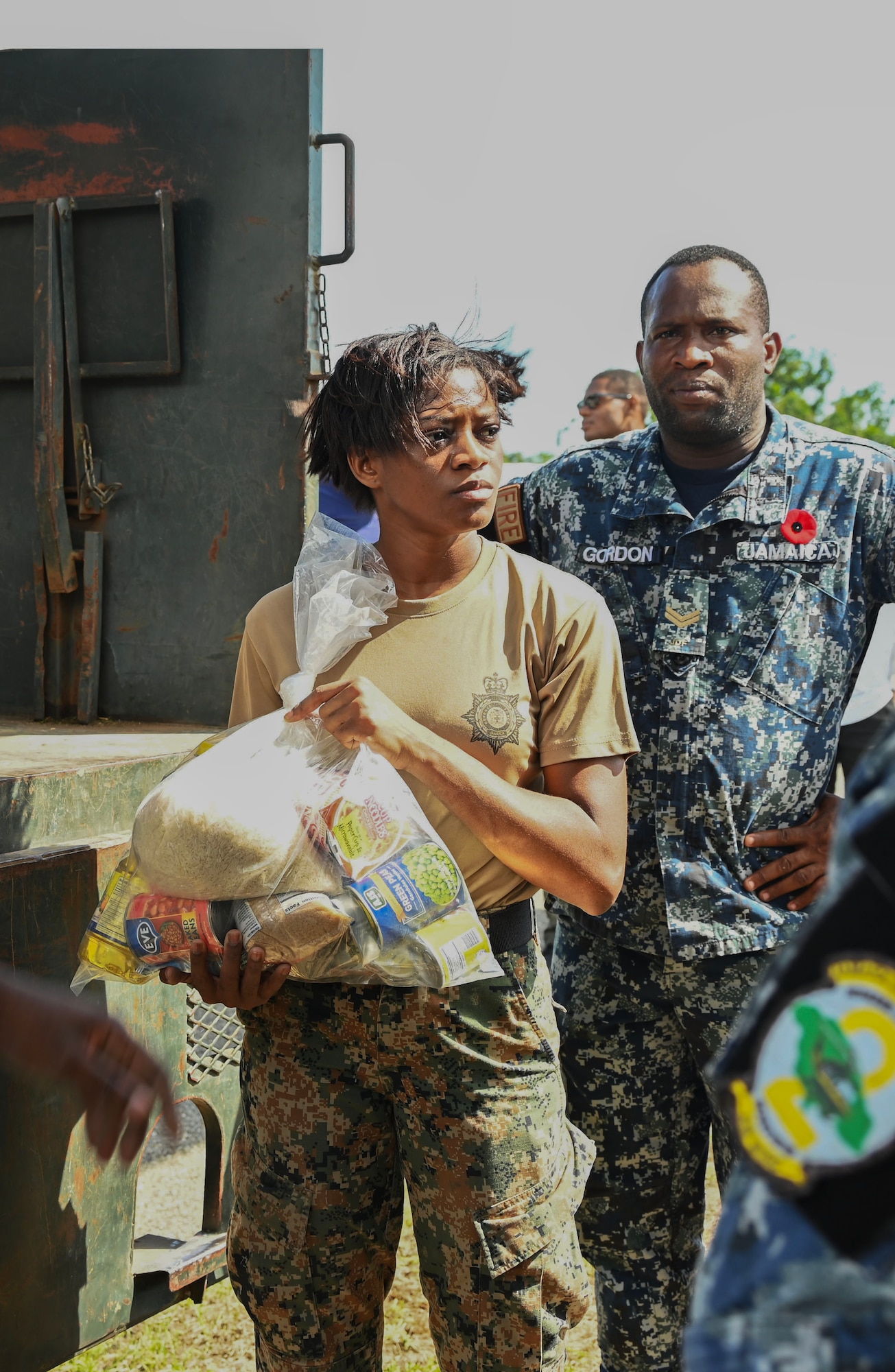 A woman holds a bag of food.