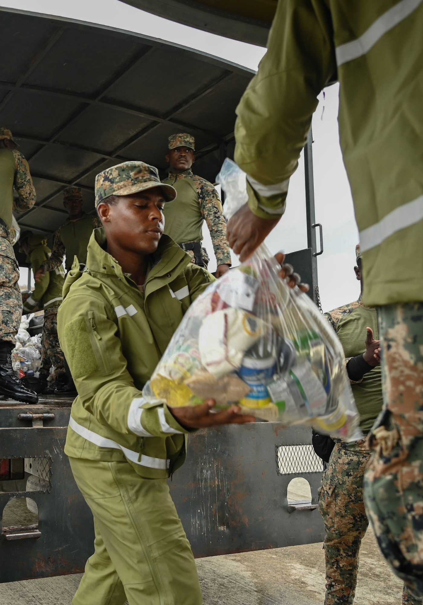 people move bags in an assembly line.