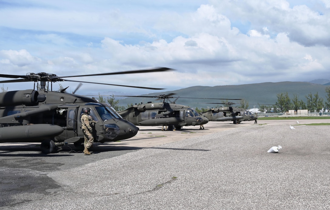 Helicopter are in a line on a flightline