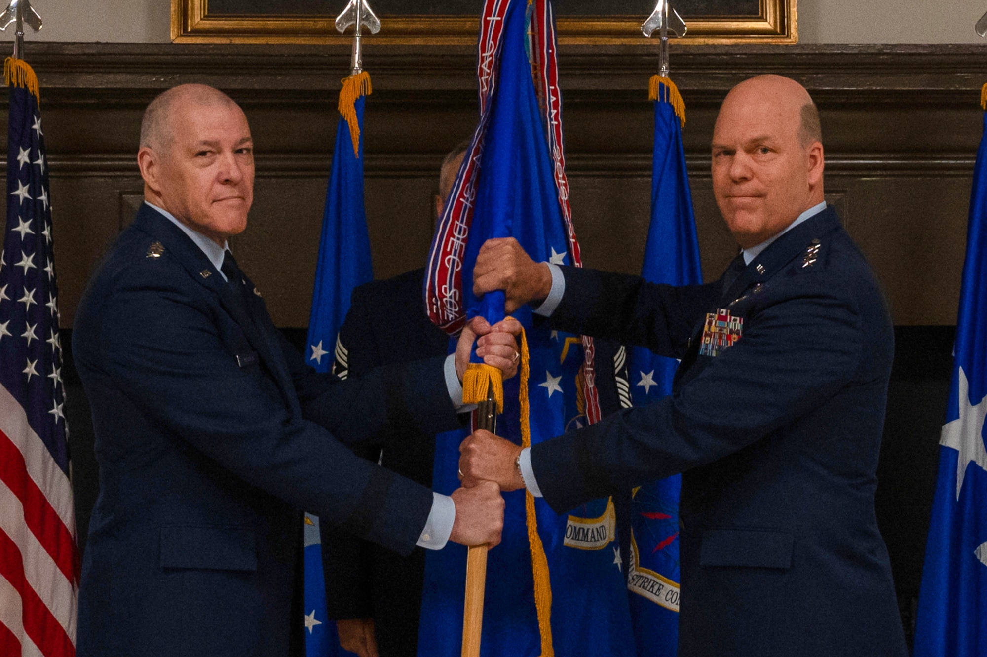 General Bussiere and General Davis pass a guidon for a change of command ceremony.