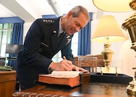 Gen. Ken Wilsbach signs the historic Bible used by each Air Force Chief of Staff at their swearing in ceremony. Wilsbach became the 24th CSAF on Nov. 3, 2025. (U.S. Air Force photo by Staff Sgt. Stuart Bright)