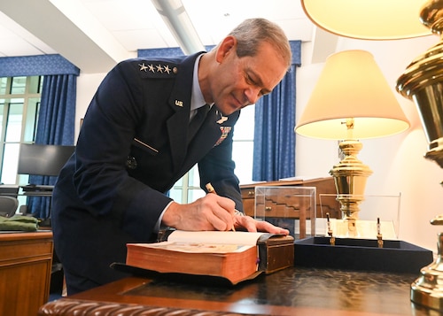Gen. Ken Wilsbach signs the historic Bible used by each Air Force Chief of Staff at their swearing in ceremony. Wilsbach became the 24th CSAF on Nov. 3, 2025. (U.S. Air Force photo by Staff Sgt. Stuart Bright)