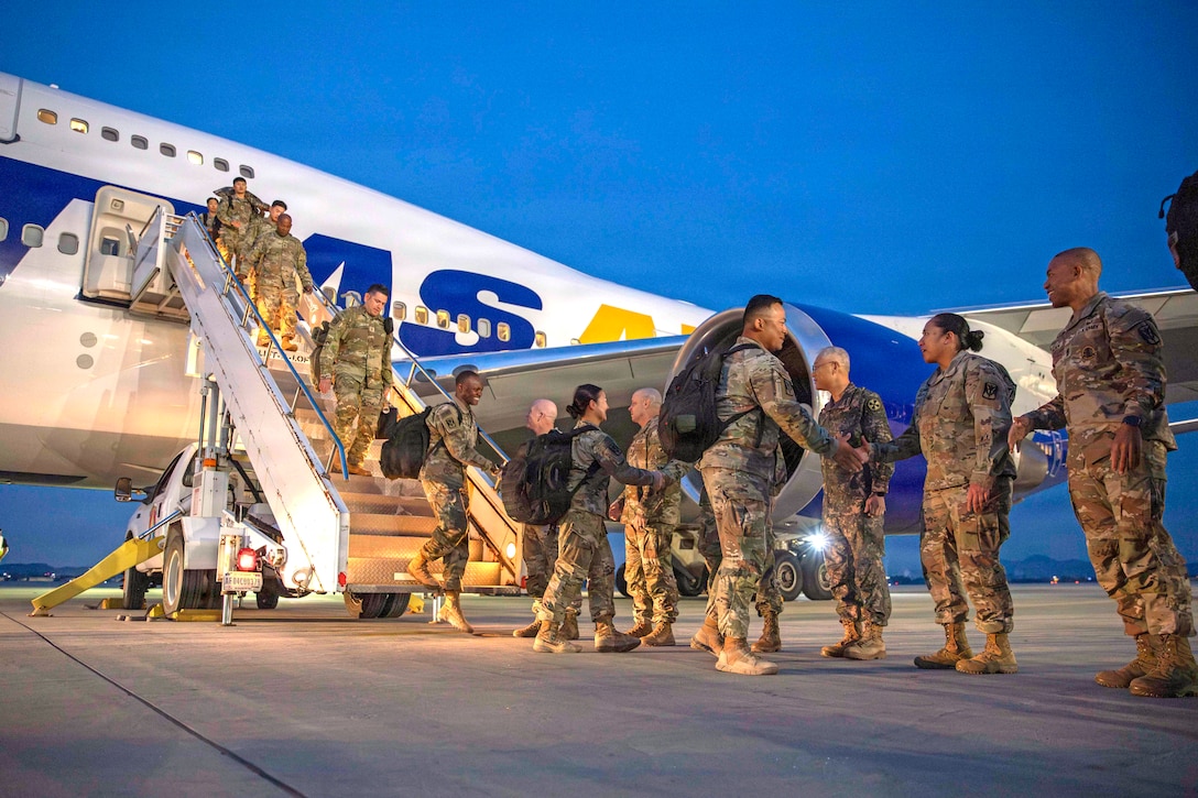 Soldiers of 2nd Battalion, 1st Air Defense Artillery Regiment, 35th Air Defense Artillery Brigade are greeted by Eighth Army and 35th ADA leaders as they deplane at Osan Air Base, South Korea, Oct. 30, 2025. The 2-1 ADA Battalion departed the Korean peninsula in March on short-notice orders to provide critical air and missile defense for key U.S. and coalition assets in the U.S. Central Command area of responsibility.