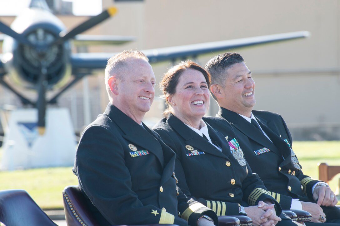 U.S. Navy Rear Adm. John Saccomando, Naval Air Force Reserve deputy commander, Capt. Page Felini, Naval Air Facility Washington commanding officer, and Capt. Christopher K. Lemon, NAFW deputy commander, listen to a speech by retired Rear Adm. Michael J. Steffen at NAFW’s change of command ceremony at Joint Base Andrews, Maryland, Oct. 17, 2025