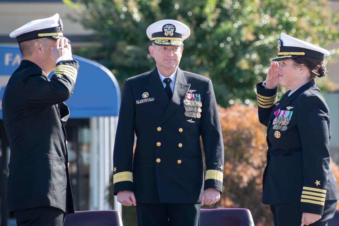 U.S. Navy Capt. Christopher K. Lemon, left, assumes command of Naval Air Facility Washington from Capt. Page Felini, right, during a change of command ceremony at Joint Base Andrews, Maryland, Oct. 17, 2025