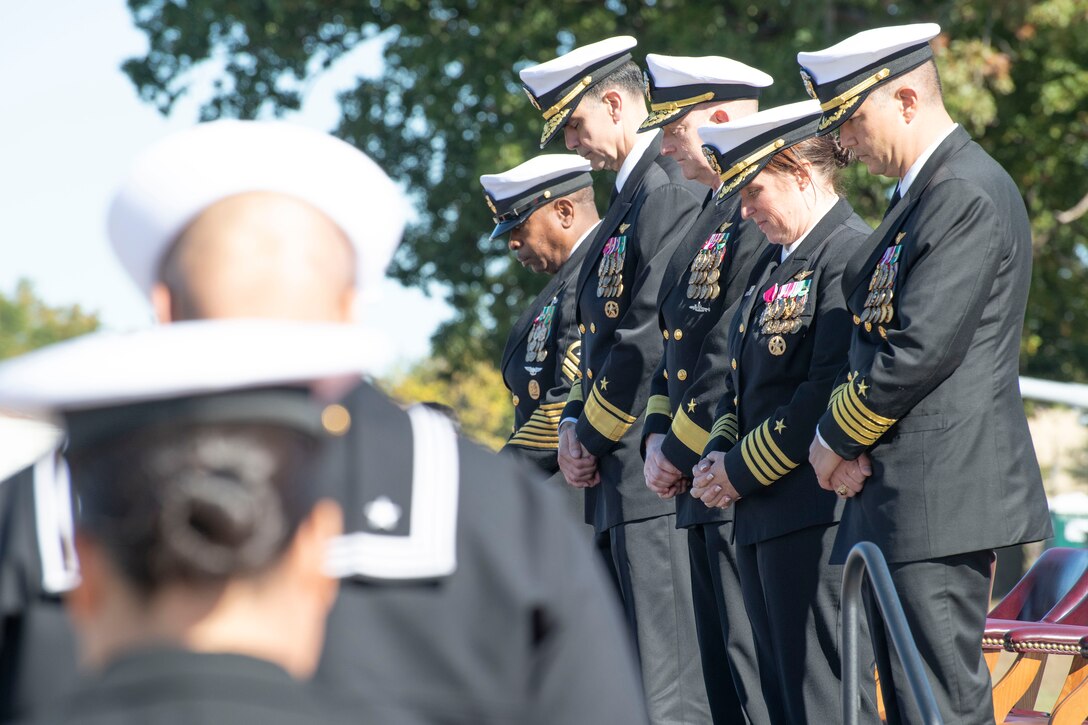 U.S. Navy Sailors bow their heads during the closing prayer at Naval Air Facility Washington’s change of command ceremony at Joint Base Andrews, Maryland, Oct. 17, 2025.