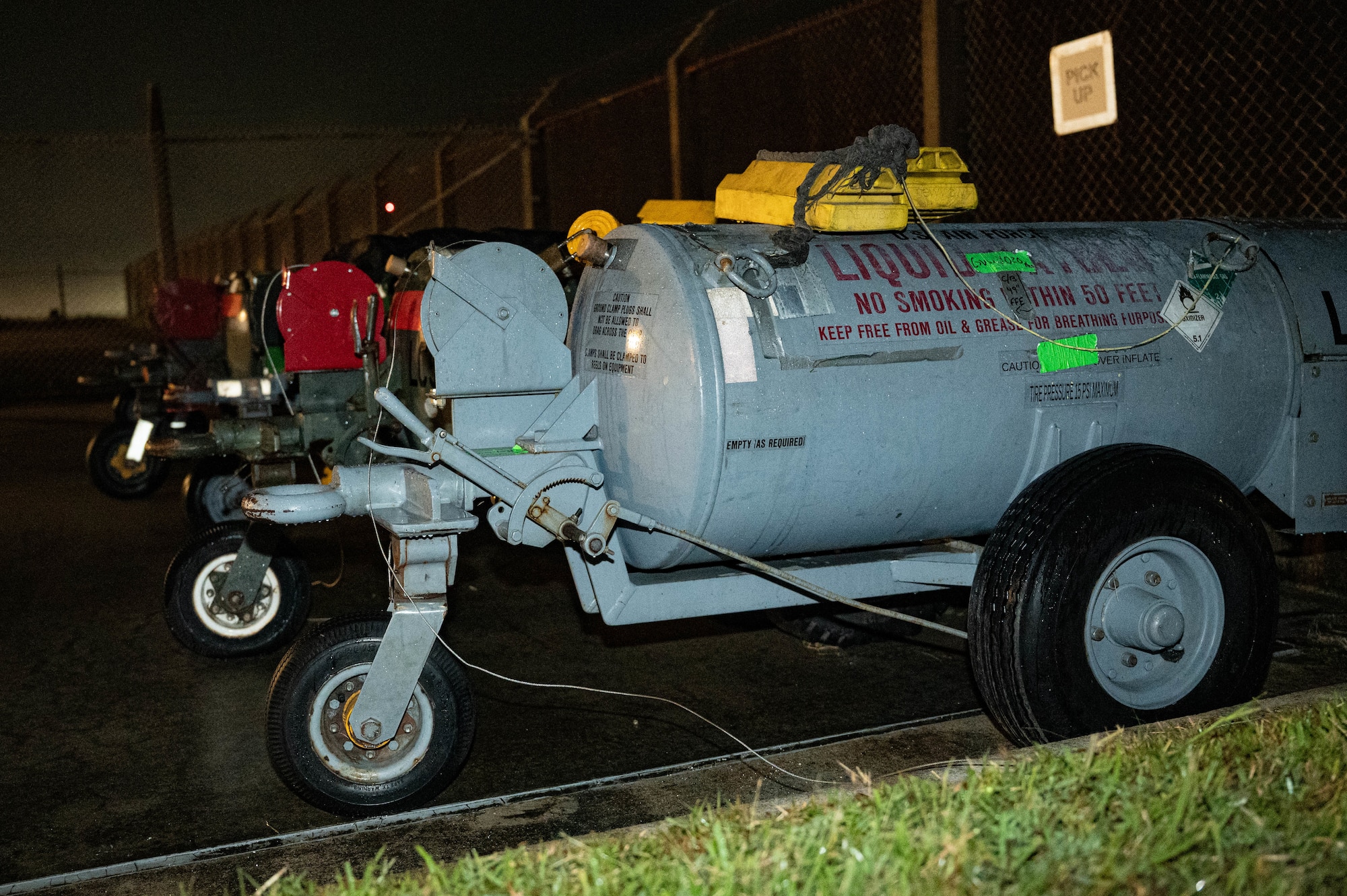 Seven liquid oxygen tanks sit in a row.