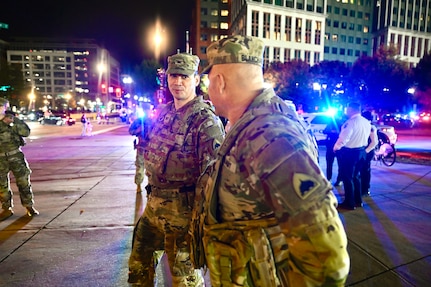 U.S. Army Col. Larry Doane, Joint Task Force - District of Columbia commander, speaks with U.S. Army Brig. Gen. Leland D. Blanchard II, Commanding General (Interim) of the District of Columbia National Guard, during a presence patrol in the Navy Yard neighborhood in Washington, D.C., Oct. 25, 2025. The D.C. Safe and Beautiful mission reinforces readiness and unity of effort among agencies dedicated to maintaining public safety in the nation’s capital.