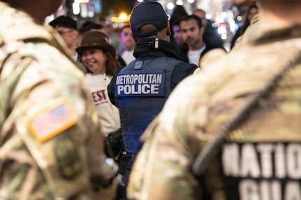 Metropolitan Police Department officers and National Guardsmen supporting the D.C. Safe and Beautiful mission patrol the streets in Washington, D.C., Oct. 31, 2025. About 2,400 National Guard members support the D.C. Safe and Beautiful mission, assisting the Metropolitan Police Department in maintaining public safety for residents, commuters and visitors throughout the District.
