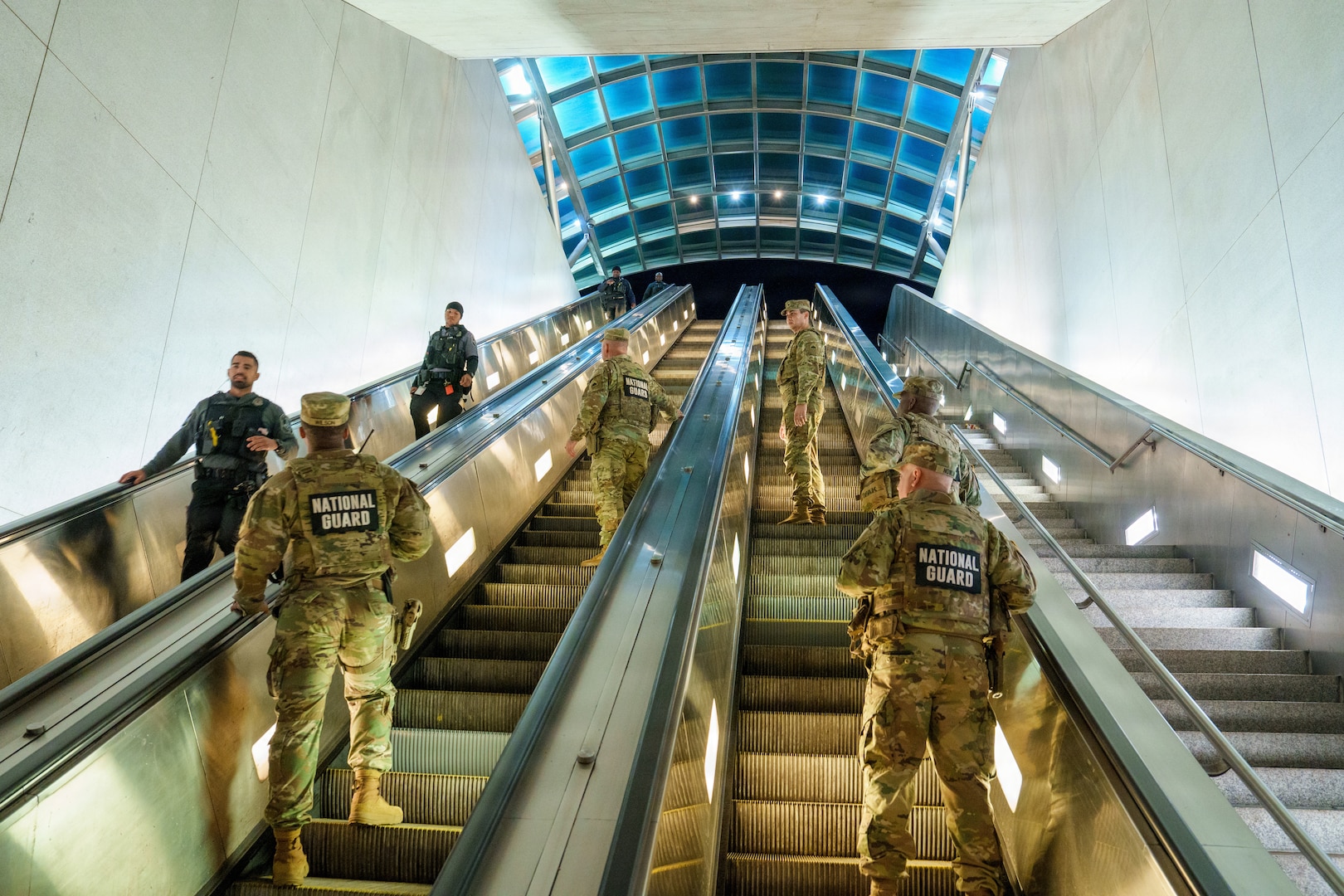 U.S. Army Col. Larry Doane, commander of Joint Task Force–District of Columbia, and members of his command team coordinate with local law enforcement investigating a reported incident in the D.C. Metro, Oct. 17, 2025, in Washington, D.C. The D.C. Safe and Beautiful mission strengthens interagency response capabilities and ensures unified action to protect the public.