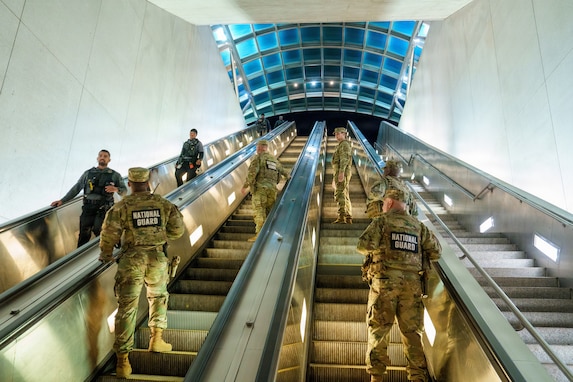 U.S. Army Col. Larry Doane, commander of Joint Task Force–District of Columbia, and members of his command team coordinate with local law enforcement investigating a reported incident in the D.C. Metro, Oct. 17, 2025, in Washington, D.C. The D.C. Safe and Beautiful mission strengthens interagency response capabilities and ensures unified action to protect the public.