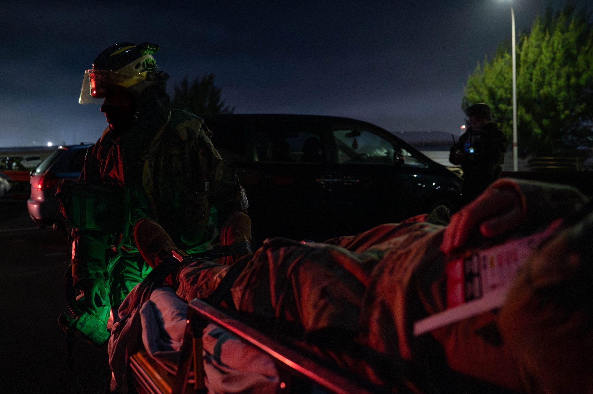 U.S. Air Force Airman assigned to the 18th Civil Engineer Squadron transport a simulated injured Airman to a medical bus during a mass casualty exercise in support of base-wide operational readiness exercise BH 26-1 at Kadena Air Base, Japan, Nov. 6, 2025. The event tested Kadena’s ability to respond to large-scale emergencies through rapid treatment and coordinated evacuation. (U.S. Air Force photo by Airman Nathaniel Jackson)