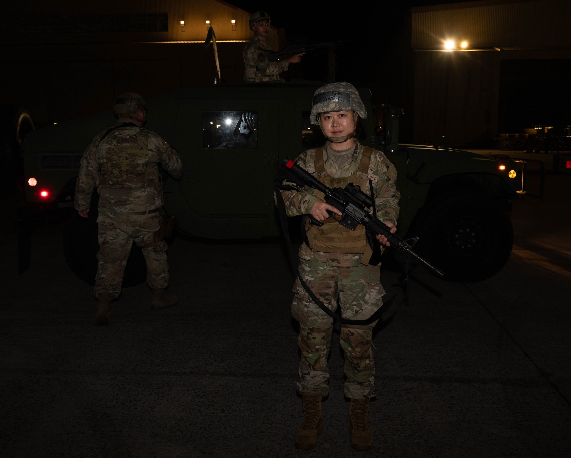 U.S. Air Force Senior Airman Qi Rupqing, 18th Contracting Squadron security forces augmentee, poses for a photo during base-wide operational readiness exercise, BH 26-1 at Kadena Air Base, Japan, Nov. 6, 2025. The exercise highlighted teamwork between maintainers and defenders to safeguard aircraft and personnel on the flightline. (U.S. Air Force photo by Airman Nathaniel Jackson)