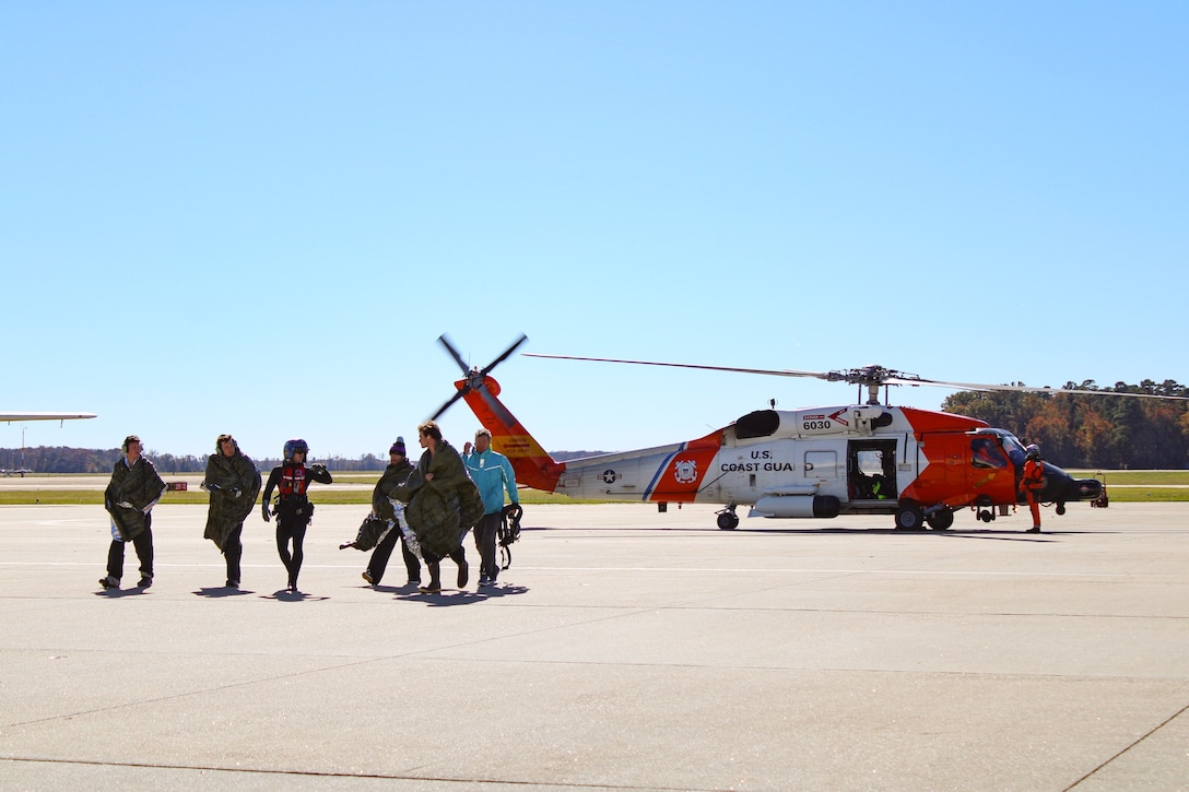 A U.S. Coast Guard MH-60 Jayhawk helicopter crew from Air Station Elizabeth City rescued five individuals from a life raft after their sailboat, Magic Bus, began taking on water 260 nautical miles offshore Cape Hatteras, N.C., Thursday, Oct. 26, 2023. The Coast Guard coordinated with the aircraft carrier USS George H.W. Bush for refueling support during the long-distance rescue. All five individuals were recovered in good health and transported safely to Air Station Elizabeth City. (U.S. Coast Guard photo by Fireman Madilynn Herrell)