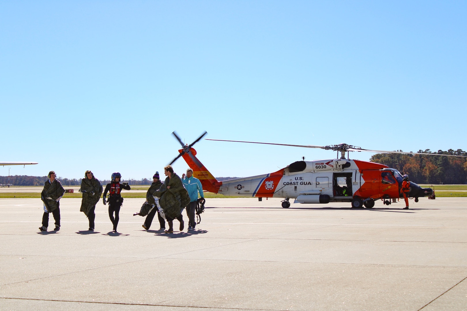 A U.S. Coast Guard MH-60 Jayhawk helicopter crew from Air Station Elizabeth City rescued five individuals from a life raft after their sailboat, Magic Bus, began taking on water 260 nautical miles offshore Cape Hatteras, N.C., Thursday, Oct. 26, 2023. The Coast Guard coordinated with the aircraft carrier USS George H.W. Bush for refueling support during the long-distance rescue. All five individuals were recovered in good health and transported safely to Air Station Elizabeth City. (U.S. Coast Guard photo by Fireman Madilynn Herrell)