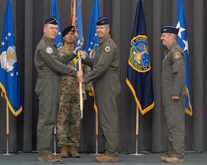 Gen. S.L. Davis, left, commander of Air Force Global Strike Command, passes the Eighth Air Force guidon to Maj. Gen. Ty Neuman