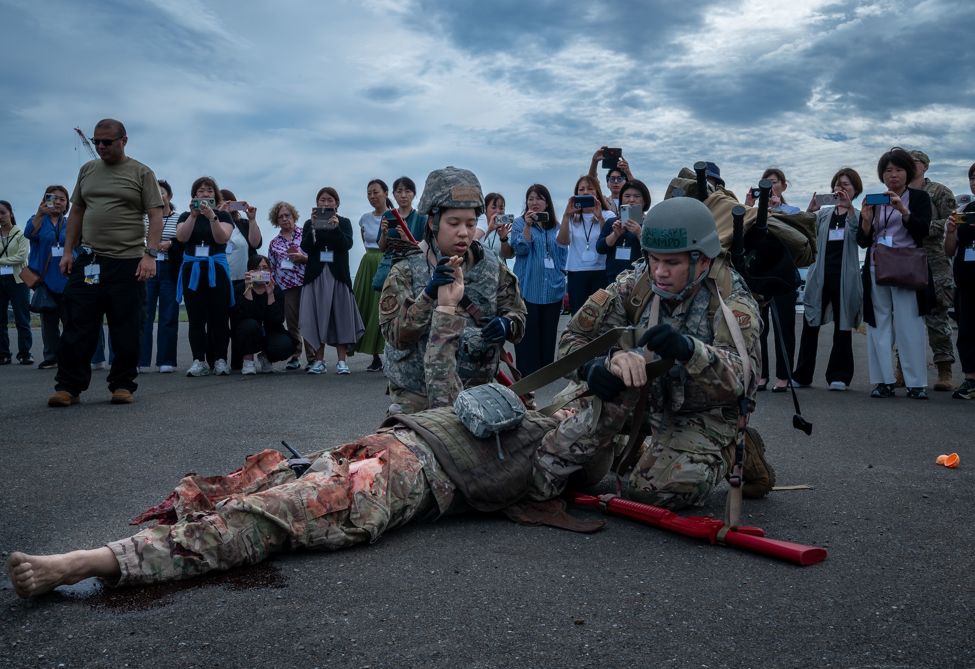 U.S. Air Force Airman 1st Class Diamond King, 374th Surgical Operations Squadron medical technician, and Capt. Joseph Ocampo, 374th Healthcare Operation Squadron urgent care clinical nurse, demonstrates tactical combat casualty care.