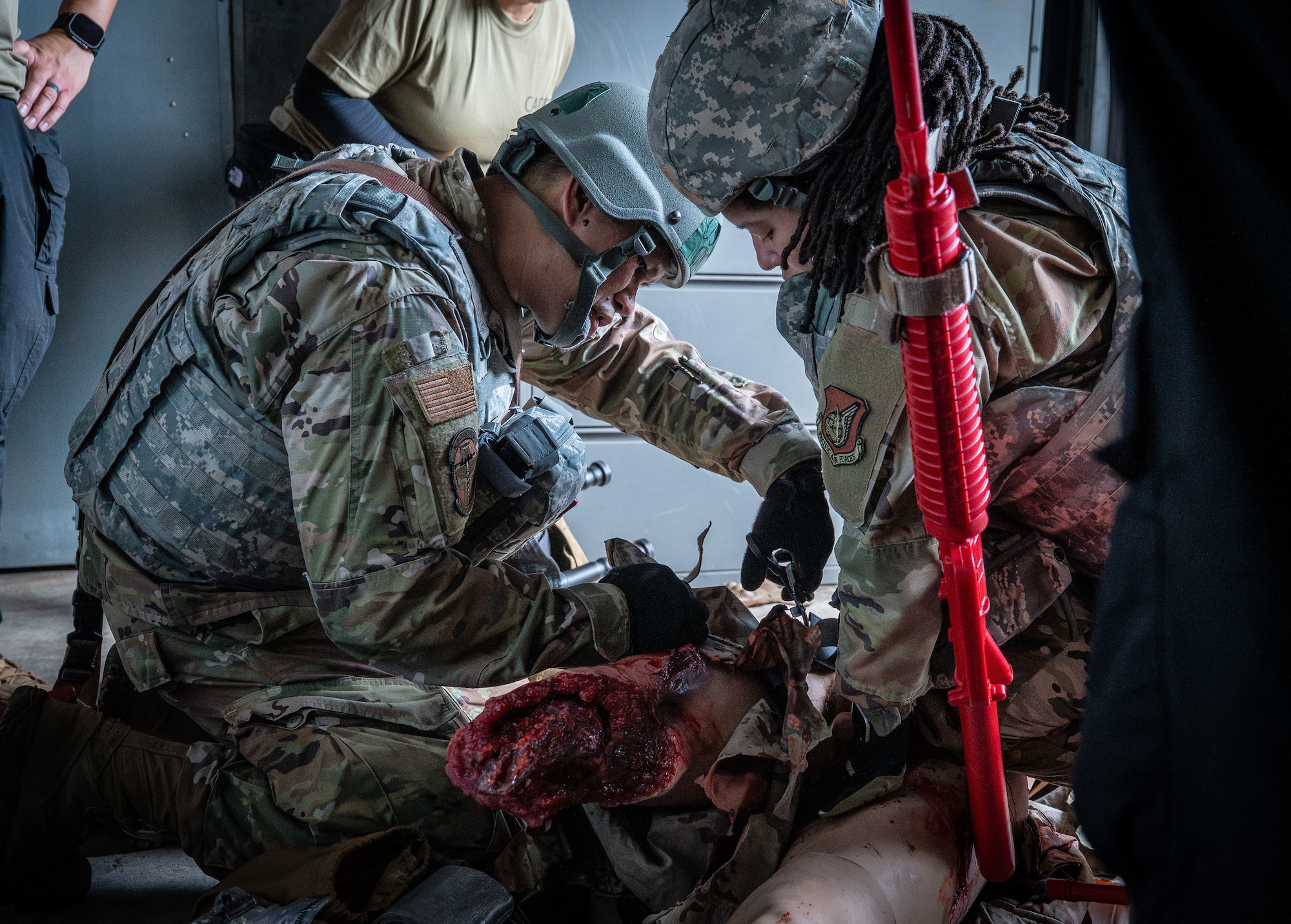 U.S. Air Force Airman 1st Class Diamond King, 374th Surgical Operations Squadron medical technician, and Capt. Joseph Ocampo, 374th Healthcare Operation Squadron urgent care clinical nurse, demonstrates tactical combat casualty care.