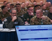 Military members attend a conference.