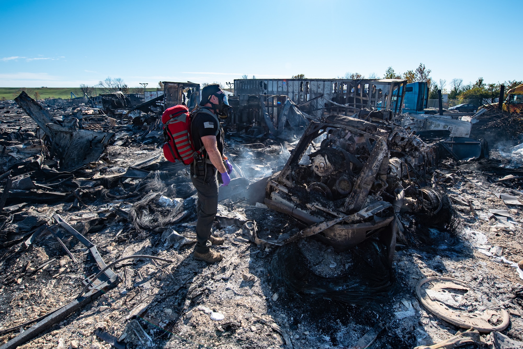 Members of the Kentucky National Guard’s 41st Civil Support Team survey the site of a fatal civilian airplane crash in Louisville, Ky., Nov. 5, 2025. The team is testing air quality to evaluate the presence of toxic chemicals. (U.S. Air National Guard photo by Phil Speck)
