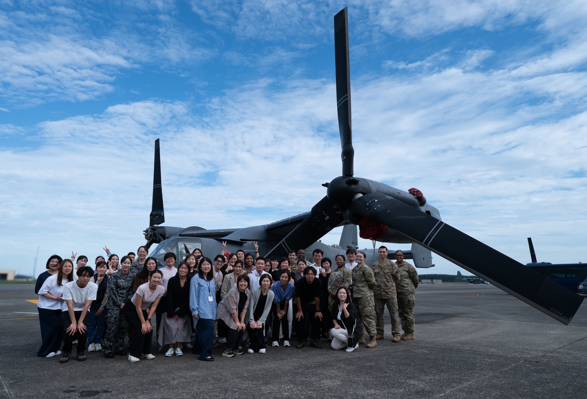 Participants from the Yokota Nurse Symposium pose in front of a CV-22 Osprey.