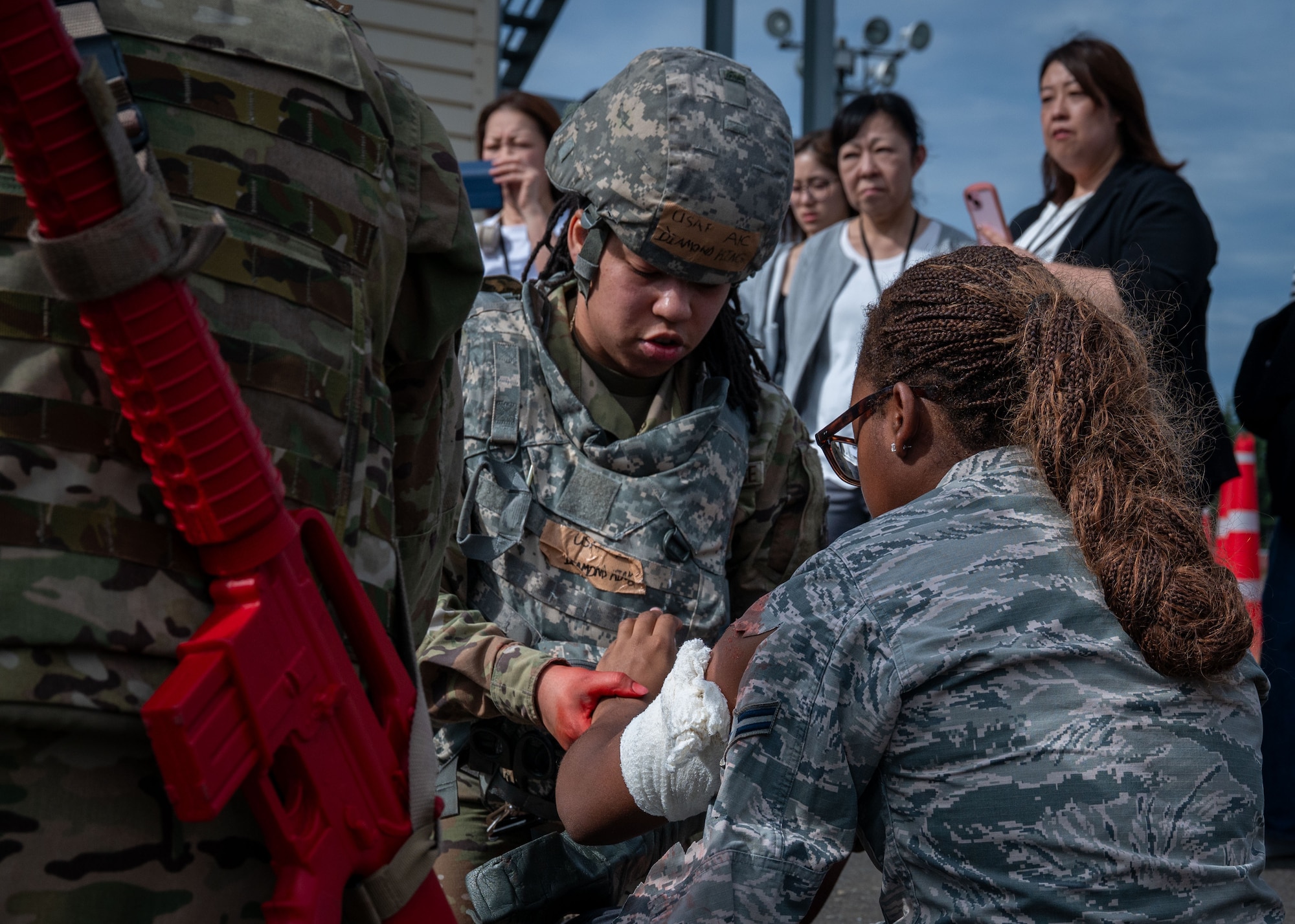 U.S. Air Force Airman 1st Class Diamond King, 374th Surgical Operations Squadron medical technician, demonstrates tactical combat casualty care.