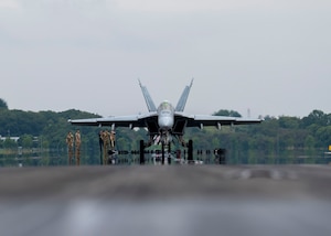 A U.S. Navy F/A-18F Super Hornet pauses on the flightline after testing an aircraft arresting system.
