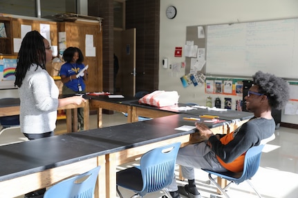 The D.C. National Guard Counterdrug Drug Demand Reduction Outreach team delivers a drug prevention presentation to students at Ballou STAY Opportunity Academy on Oct. 24, 2025, in recognition of Red Ribbon Week in Washington D.C. The session aimed to spark candid discussions about substance misuse and highlight the importance of making healthy, informed decisions. The DDRO outreach team emphasized its ongoing mission to combat drug abuse through education, awareness, and interactive programs designed to empower young people.