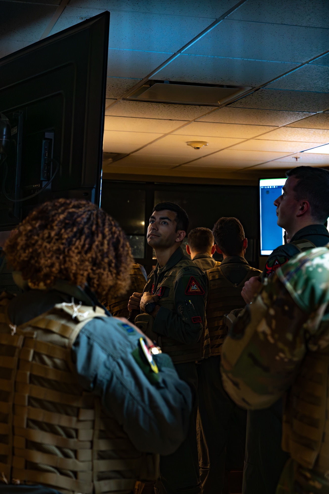 An air crew watching a PowerPoint.