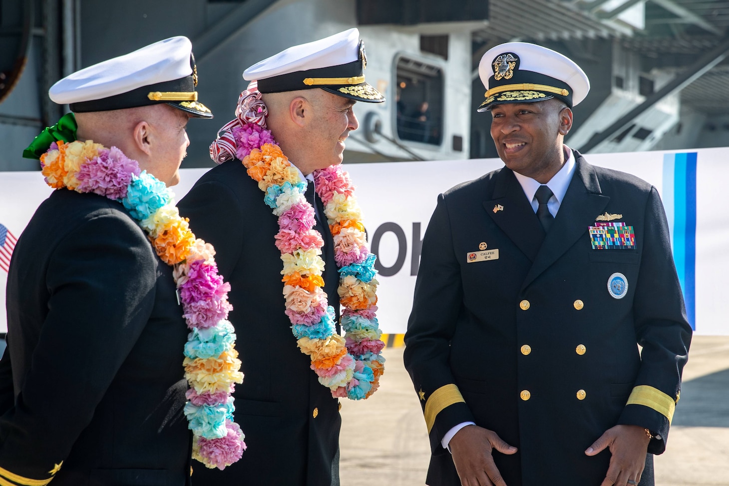 Rear Adm. Eric Anduze, center, commander, Carrier Strike Group 5, and Capt. Timothy Waits, commanding officer of Nimitz-class aircraft carrier USS George Washington (CVN 73), speak to Rear Adm. Sharif H. Calfee, Commander, U.S. Naval Forces Korea, during a welcoming ceremony at Busan Naval Base, Busan, Republic of Korea, Nov. 5, 2025.