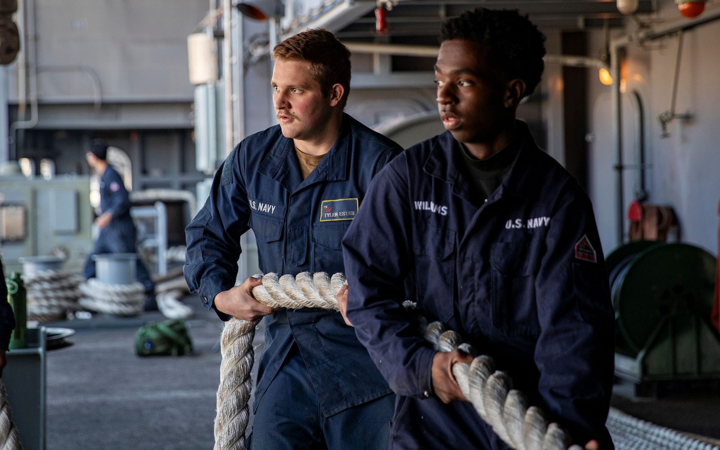 Boatswain’s Mate Seaman Tyler Estes, left, from Tennessee, and Boatswain’s Mate Seaman Nicholas Williams, from Alabama, both assigned to deck department, heave a mooring line on the fantail during a sea-and-anchor evolution aboard Nimitz-class aircraft carrier USS George Washington (CVN 73) while pulling into Busan, Republic of Korea, Nov. 5, 2025.