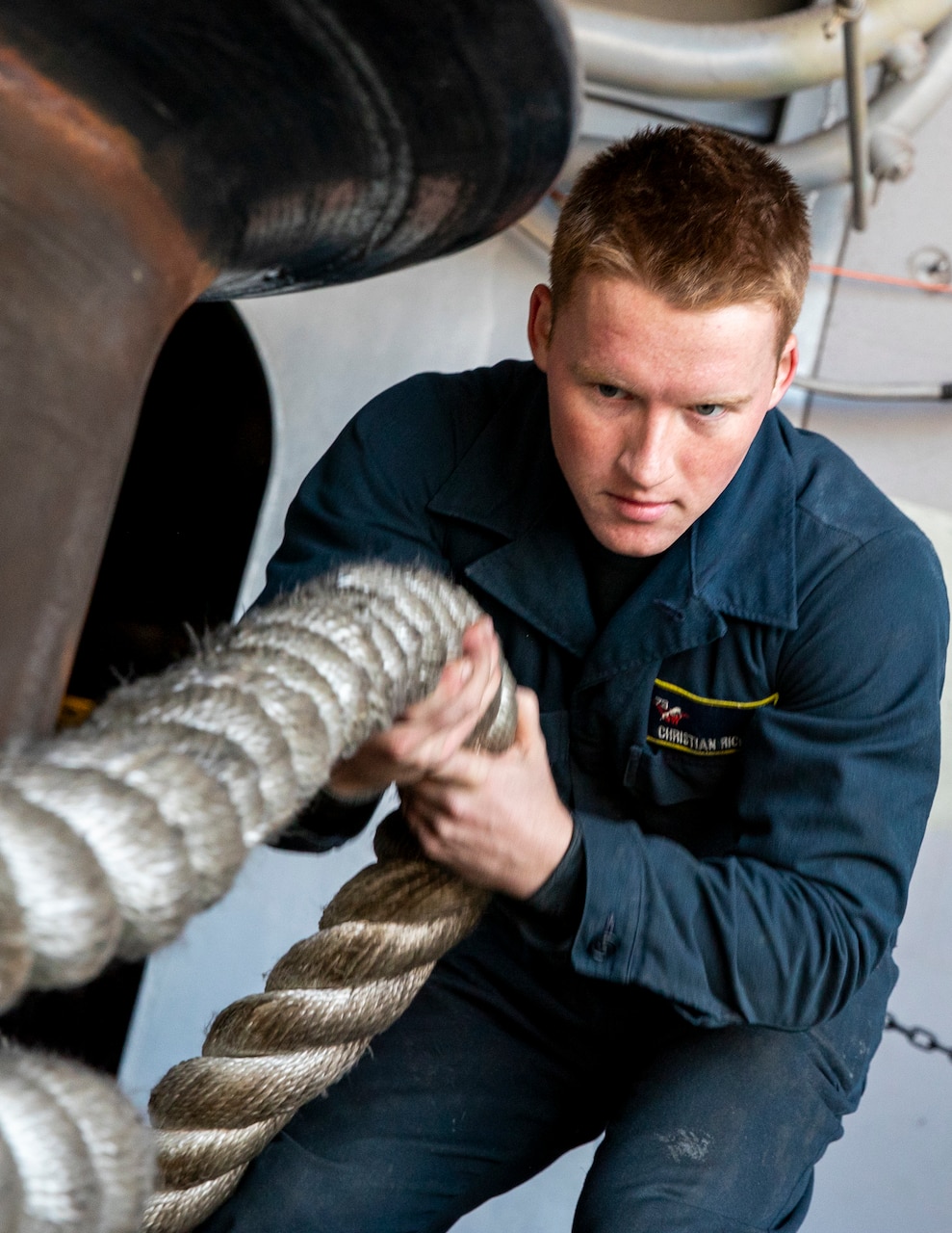 Boatswain’s Mate Seaman Christian Richter, from Pennsylvania, assigned to deck department, heaves a mooring line around a capstan on the fantail during a sea-and-anchor evolution aboard Nimitz-class aircraft carrier USS George Washington (CVN 73) while pulling into Busan, Republic of Korea, Nov. 5, 2025.